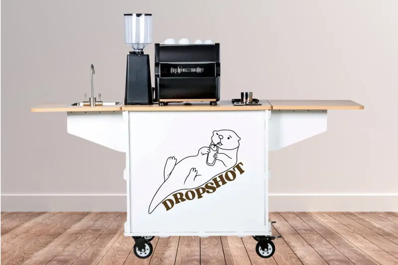 Dropshot Coffee mobile cart with otter logo, espresso machine and grinder