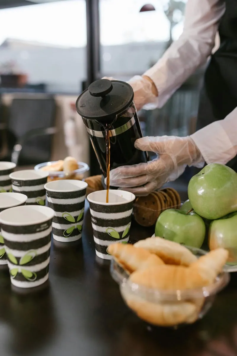 Professionals gathered around coffee service at corporate event