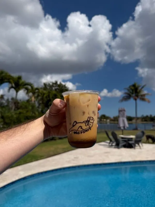 Dropshot Coffee cart setup at outdoor event with white tent and professional equipment